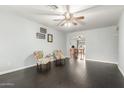 Bright living room showcasing dark wood floors, ceiling fan, and an open floor plan at 627 W Flower Ave, Mesa, AZ 85210