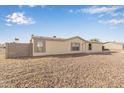 Beige one-story home in a desert landscape, under a beautiful blue sky with scattered clouds at 6901 W Patricia Ann Ln, Peoria, AZ 85382