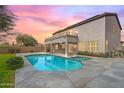 Relaxing backyard pool with a covered patio and a second story balcony at 7387 W Remuda Dr, Peoria, AZ 85383