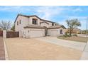 Two-story home with desert landscaping, three car garage, and neutral color palette at 7387 W Remuda Dr, Peoria, AZ 85383