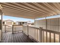 Covered front porch featuring white railings and a dark wood-look deck, perfect for relaxing at 7750 E Broadway Rd # 54, Mesa, AZ 85208