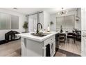 Bright kitchen island featuring a sleek sink and modern faucet with space for pet bed at 7840 W Bonitos Dr, Phoenix, AZ 85035