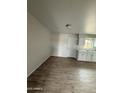 Bright kitchenette with white cabinets and modern flooring at 7955 W Mackenzie Dr, Phoenix, AZ 85033