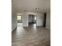 Spacious living room with modern flooring, neutral colors and natural light at 7955 W Mackenzie Dr, Phoenix, AZ 85033