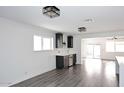 Bright living room featuring modern lighting, sleek wet bar area, and light gray flooring at 8335 E Montecito Ave, Scottsdale, AZ 85251