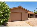 Single-story home with an attached garage and a low-maintenance front yard with rock landscaping at 8538 E Vista Dr, Scottsdale, AZ 85250
