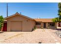 Exterior of single-story home features a well-kept front yard with low maintenance landscaping and an attached garage at 8538 E Vista Dr, Scottsdale, AZ 85250