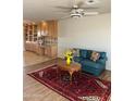 Inviting living room with built-in cabinets, a ceiling fan, and decorative rug at 8538 E Vista Dr, Scottsdale, AZ 85250