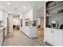 Modern kitchen featuring white cabinets, stainless steel appliances, and decorative backsplash at 8709 E Mackenzie Dr, Scottsdale, AZ 85251