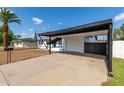 Carport of a single-story home with a white door and adjacent fence at 9033 N 15Th Dr, Phoenix, AZ 85021