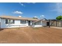 Charming single-story home with carport and white exterior at 9033 N 15Th Dr, Phoenix, AZ 85021