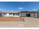 Charming single-story home with carport and white exterior at 9033 N 15Th Dr, Phoenix, AZ 85021