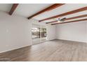 Spacious living room with wood beam ceiling and view to the backyard at 9033 N 15Th Dr, Phoenix, AZ 85021