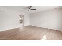 Spacious living room with fan, wood floors, and view to the backyard at 9033 N 15Th Dr, Phoenix, AZ 85021