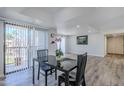 Inviting dining area with modern table set, wood floors, and sliding door to the balcony at 9275 E Mission Ln # 206, Scottsdale, AZ 85258