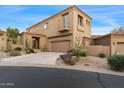 Beautiful two story home with a driveway lined with native desert plants and succulents at 9280 E Thompson Peak Pkwy # 25, Scottsdale, AZ 85255