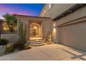 A charming front entrance welcomes you with native desert plants and stone walkway at 9280 E Thompson Peak Pkwy # 25, Scottsdale, AZ 85255