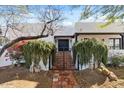 Inviting gated front entrance with lush greenery and brick pathway at 9331 E La Posada Ct, Scottsdale, AZ 85255