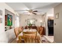 Inviting dining room features a classic wooden table with seating for six and a decorative stained glass window at 9345 N 92Nd St # 201, Scottsdale, AZ 85258