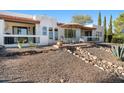 Inviting back patio with a covered seating area and a landscaped backyard at 100 N Lazy Fox Rd # 3, Wickenburg, AZ 85390
