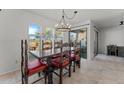 Bright dining room featuring a stylish chandelier and large windows with picturesque outdoor views at 100 N Lazy Fox Rd # 3, Wickenburg, AZ 85390