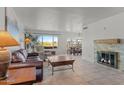 Bright living room features tile flooring, a cozy fireplace, and large windows with beautiful views at 100 N Lazy Fox Rd # 3, Wickenburg, AZ 85390
