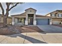 Inviting single-story home with desert landscaping, and a convenient two-car garage at 10353 W Atlantis Way, Tolleson, AZ 85353