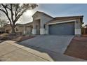 Stylish single-story home with a two-car garage and well-maintained landscaping at 10353 W Atlantis Way, Tolleson, AZ 85353
