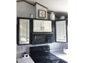 Kitchen features traditional cabinets with white faces and black trim and includes modern appliances at 111 S Greenfield Rd # 426, Mesa, AZ 85206