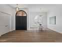 Open concept dining room with hardwood floors, modern light fixtures, and designer furniture at 11232 E Palomino Rd, Scottsdale, AZ 85259