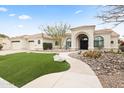 Stunning home featuring desert landscaping, a stone walkway, and mature trees in the front yard at 11232 E Palomino Rd, Scottsdale, AZ 85259
