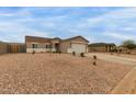 Well-maintained home with a large front yard adorned with desert landscaping at 11731 W Cabrillo Dr, Arizona City, AZ 85123