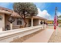 Close-up of a charming front entrance with desert landscaping, quaint features, and neutral tones at 13602 W Ballad Dr, Sun City West, AZ 85375