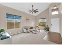 Bright living room featuring neutral walls, carpet flooring, ceiling fan, and comfortable seating at 13641 W Solano Dr, Litchfield Park, AZ 85340