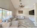 Comfortable living room with a large sectional sofa, modern rug and a large window for lots of light at 13641 W Solano Dr, Litchfield Park, AZ 85340