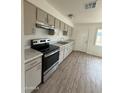 Well-lit kitchen featuring ample cabinetry, modern appliances, and durable countertop at 1853 W Burgess Ln, Phoenix, AZ 85041
