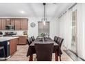 Dining area featuring modern light fixture and sliding glass doors to the outside at 2067 N Marketside Ave, Buckeye, AZ 85396
