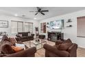 Cozy living room with comfortable seating, neutral tones, and a modern fireplace at 2067 N Marketside Ave, Buckeye, AZ 85396