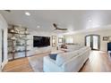 Open-concept living room featuring built-in shelves, modern TV setup, and luxury light fixtures at 2410 E Cholla St, Phoenix, AZ 85028