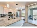 Modern kitchen featuring a granite island, stainless steel appliances, and stylish pendant lighting at 2425 W Bronco Butte Trl # 2008, Phoenix, AZ 85085