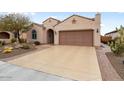 Single-story home with desert landscaping and a tan colored two-car garage at 26234 W Matthew Dr, Buckeye, AZ 85396