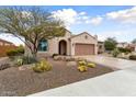 Inviting single-story home boasts a two-car garage and beautiful desert landscaping at 26234 W Matthew Dr, Buckeye, AZ 85396