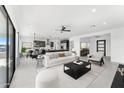 Bright open-concept living room with modern furniture, with a view of the kitchen and dining area at 7259 S 221St Ave, Buckeye, AZ 85326