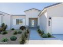 Inviting front entrance with desert landscaping, showcasing the home's architectural details and curb appeal at 7271 S 221St Ave, Buckeye, AZ 85326