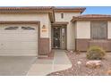 Inviting home entrance with desert landscaping and a secure screen door at 10762 W Cimarron Dr, Peoria, AZ 85373