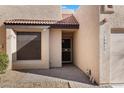 Close up view of a home's entrance, showing the front door, address numbers, and adjacent desert landscaping at 10815 N 117Th Pl, Scottsdale, AZ 85259