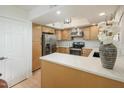 Kitchen featuring stainless steel appliances, light wood cabinets, and stylish countertop at 12222 N Paradise Village S Pkwy # 337, Phoenix, AZ 85032