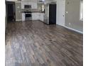 Bright kitchen features white cabinets, stainless steel appliances, and wood-look flooring at 15625 N 25Th St # 21, Phoenix, AZ 85032