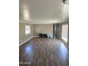 Spacious living room with wood-look floors and lots of natural light from a window at 15625 N 25Th St # 21, Phoenix, AZ 85032