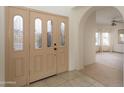 Inviting foyer featuring tile flooring, arched doorways, and clear view into the formal living area at 15644 S 13Th Pl, Phoenix, AZ 85048